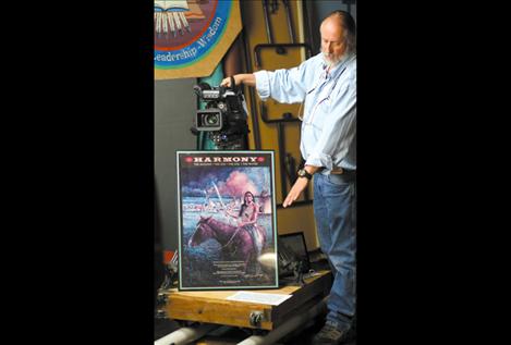 Dr. Frank Tyro demonstrates how a custom-built set of tracks helps to serve the station during a tour. The KSKC station is located under the SKC library and has produced more than 3,500 hours of local programming for local viewers.