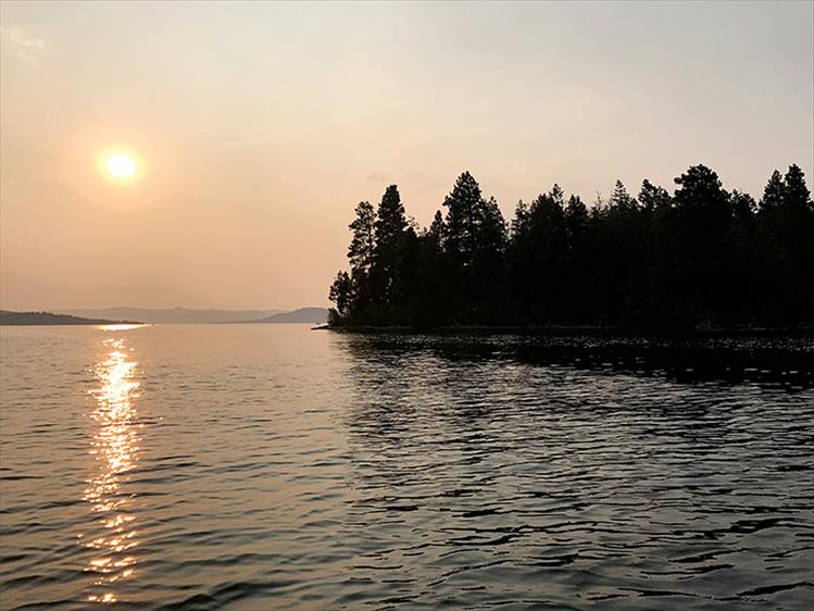 Smoke from local and distant fires casts a golden glow at sunset.