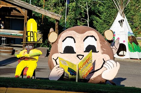 The Ronan Library crew turned a hay bale into Curious George, a story book character. 