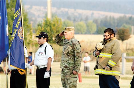 Army Reserve soldier Paul Adams salutes the flag.