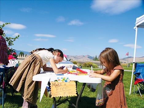 Children make kites at the Flathead Human Rights Coalition table.