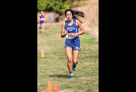 Lady Bulldog Karolyna Buck races on her home course.