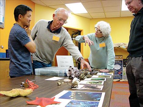 COPUS conference attendees discuss a presentation on tide pool animal adaptations.