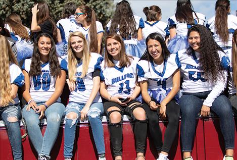 The Lady Bulldogs ride on a float during the parade.