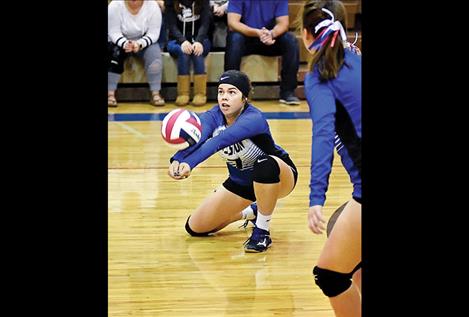 Lady Dawg Azia Umphrey bumps a serve during Mission High School's  homecoming game against  Powell County.