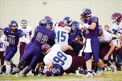 Charlo Viking football players and Clark Fork Mountain Cat football players come together during Friday night's homecoming game.