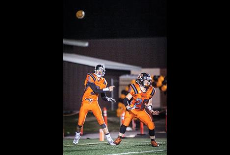 Trapper McAllister, number 5, of the Ronan Chiefs, throws a pass during the homecoming game.