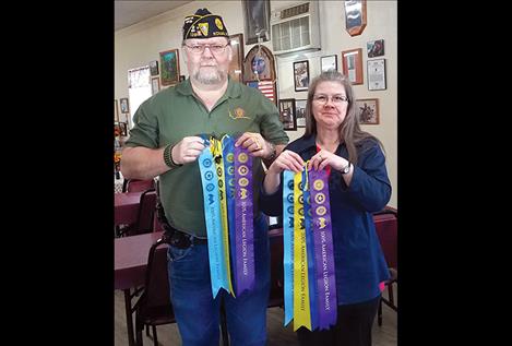 Commander of Ronan Post No.138 Glen Sharbono and President of Ronan Unit No.138 Lorie Noble display ribbons awarded to the Post and Auxiliary.