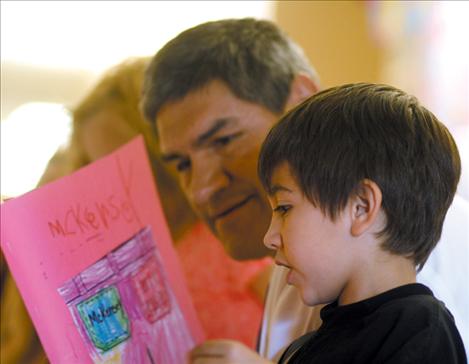 Connor Durglo reads a story he wrote during class to his dad, middle school principal Dan Durglo.