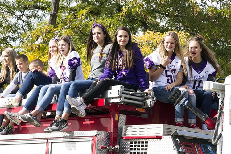 Polson High School athletes ride atop a Polson firetruck in Friday's homecoming parade.