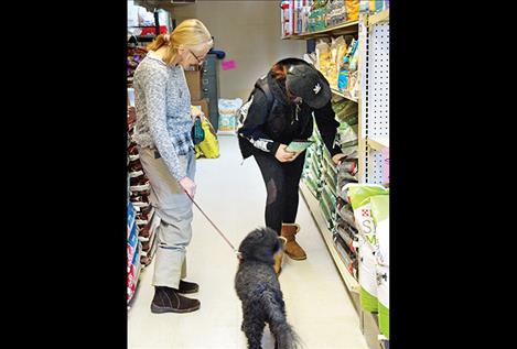 Abbe Moran helps a customer at Headley Family Feed in Arlee.