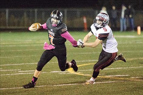 Ronan Chief quarterback Eric Dolence tries to slip past the Browning defender.