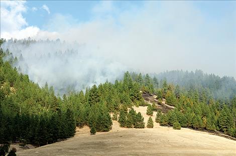 Fire moves up the hillside in Arlee, near Dumontier Road, and burns into the timber. The fire was contained on Friday, Oct. 26, after burning for three days.