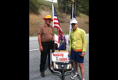 Lewis stands with Mike Ehredt, a runner who logged two trips across America, placing a flag at every mile marker in honor of  every U.S. service member killed in Iraq and Afghanistan.
