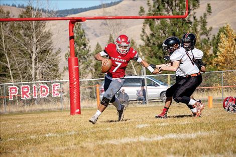 Warrior  quarterback Lane Schall looks for some running room.