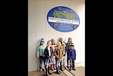 Children from Pablo Elementary School sport hand-knitted hats made by a knitter in Freedom, Pennysylvania. 