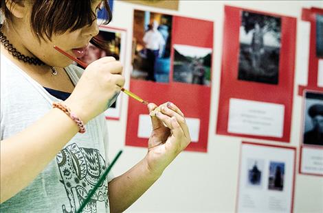 A student participates in an art project during Heritage Night.