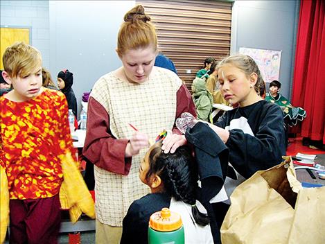 Students wait to be transformed by the magic of theater makeup.