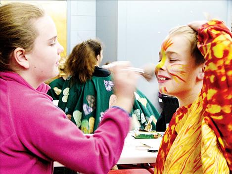 Cayden Clark helps prepare Natalee Coulson to play Snow White.