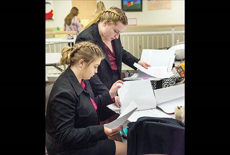 Polson High School Speech and Debate team members Allison Dodson (standing) and  Madeleine Bissegger  (sitting) had only minutes to prepare their cases.