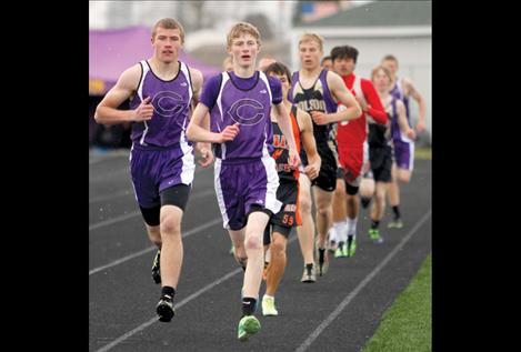 Dalton Delaney, right, and Tristan Santee lead the field after one lap in the boys’  1,600-meter run at the Lake County meet.