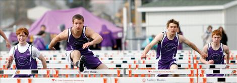 Senior Tra Ludeman leads teammates Michael Delaney, left, Jesse Long and Kail Pope over the hurdles at the Lake County Invitational track meet April 30 in Ronan.