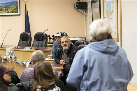 Polson  Police Chief Wade Nash listens to comments from a concerned  business owner.