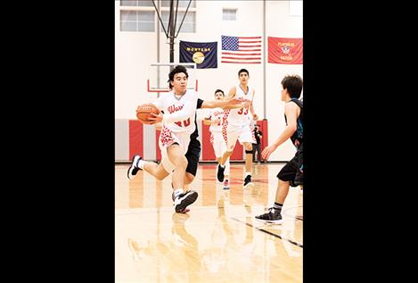 Warrior Zach YoungRunningCrane heads to the hoop.