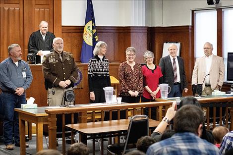 Judge James Manley stands behind newly sworn in officials,  including: Justice of the Peace Randal Owens, Lake County Sheriff Don Bell, Clerk and Recorder Paula Holle, Treasurer/Assessor Robin G. Vert-Rubel, County Superintendent of Schools Carolyn Hall, County Commissioner Gale Decker and County Attorney Steven Eschenbacher. 