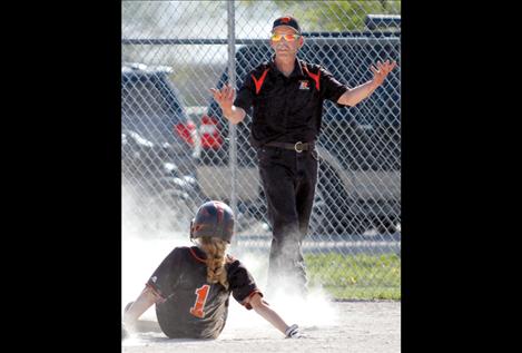 Maidens head coach Brad Benson reacts as the ump calls Samantha Colman “out” at third base.