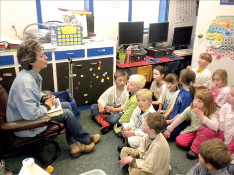 Primary students at Valley View Elementary School listen while Edna Lemm begins the day’s art  lesson with the history of the artist and samples of their artwork.