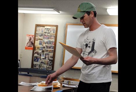 Thomas Fleming lays out work prints before David Spear’s advanced black and white photography class.