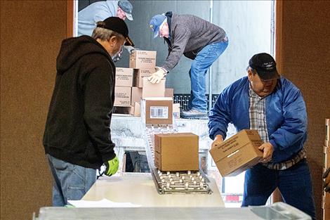 Volunteers unload 15,000 pounds of food by hand.