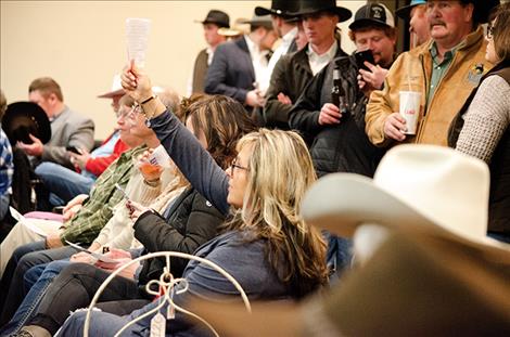 Members of the public bid on items at the 2019 Montana State Bid-Call Championship in Polson on Friday.
