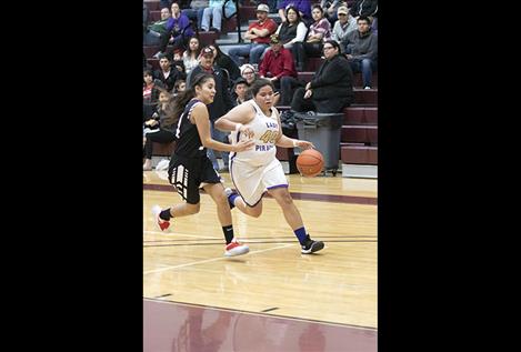 Lady Pirate  Nastasha Gravelle  races toward the hoop with the ball.