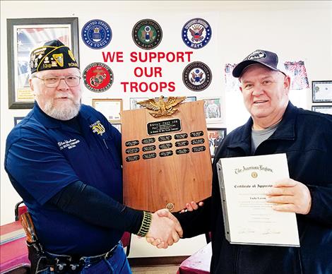 American Legion Ronan Post No. 138 Commander Glen Sharbono and fellow Legionnaire Lucky Larson pose with a plaque refurbished by Larson denoting the names of comrades transferred to "post everlasting."