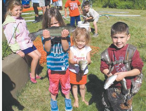 Brynn Courville, Amanda Webster, and August Courville show off their respective catches.