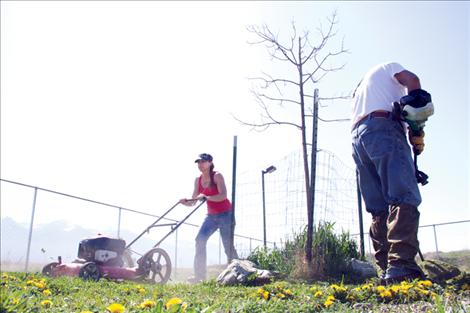 SKC faculty members Effie Clairmont and Virgil Brave Rock mow and weed-eat the backyard at Mission Valley Animal Shelter last Friday. The two have volunteered at the animal shelter for SKC’s Community Service Day for the past four years.