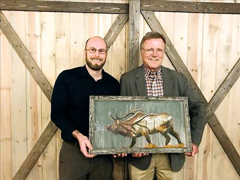 Dr. Marcus Simonich presents a gift to Dr. Ofstad during Ofstad's retirement party.