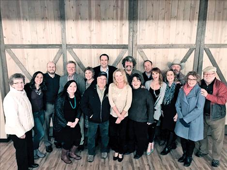 Jim Ofstad is surrounded by former staff, family and friends during his reitrement party.