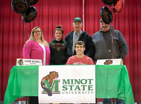 Arlee Warrior Lane Schall signs his letter of intent to play football with Minot State University, in Minot, North Dakota.