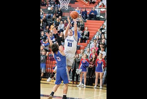 Mission Bulldog Wacey McClure slips past a defender for two points.