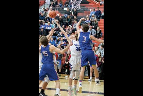 Mission Bulldog Layne Spidel battles for a rebound.