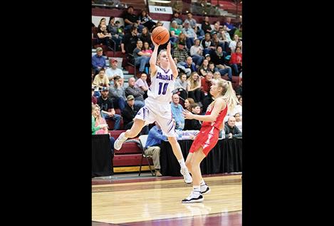 Charlo Lady Viking Kaitlin Cox swats the ball during district postseason action.