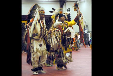 Elder Pat Pierre and his son Alan Pierre dance side-by-side during the opening ceremony Friday night.