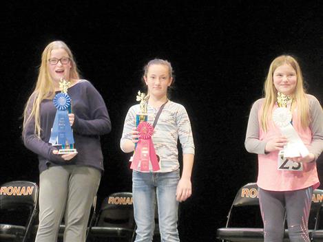 Michelle Jury, Grace Elverud and Elizabeth Cunningham, from left, pose with their spelling bee trophies.