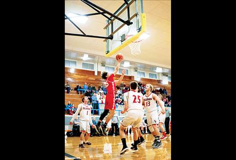 Arlee's Greg Whitesell reaches high for the basket. 