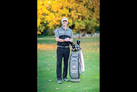 Cameron Milton, head golf professional for the Polson Bay Golf Course, poses for a photo with his clubs .