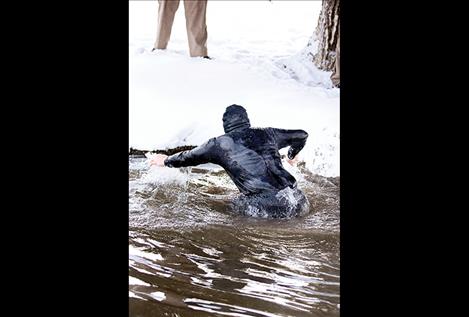 Ronan Chief of Police Ken Weaver eases his way out of Spring Creek during Saturday's Flathead Rez Polar Plunge fundraising event to support the local Special Olympics program.