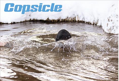 Ronan Chief of Police Ken Weaver supports Special Olympics by dipping into Spring Creek during Saturday's Flathead Res Polar Plunge fundraising event.